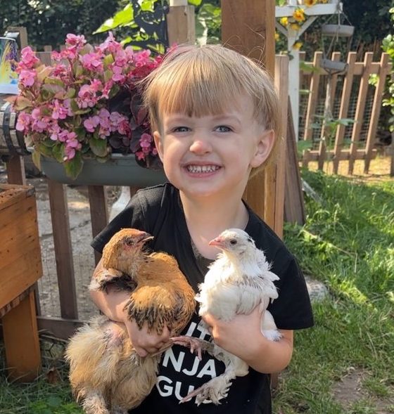 Young member of the family holding Hulk and Rizzo